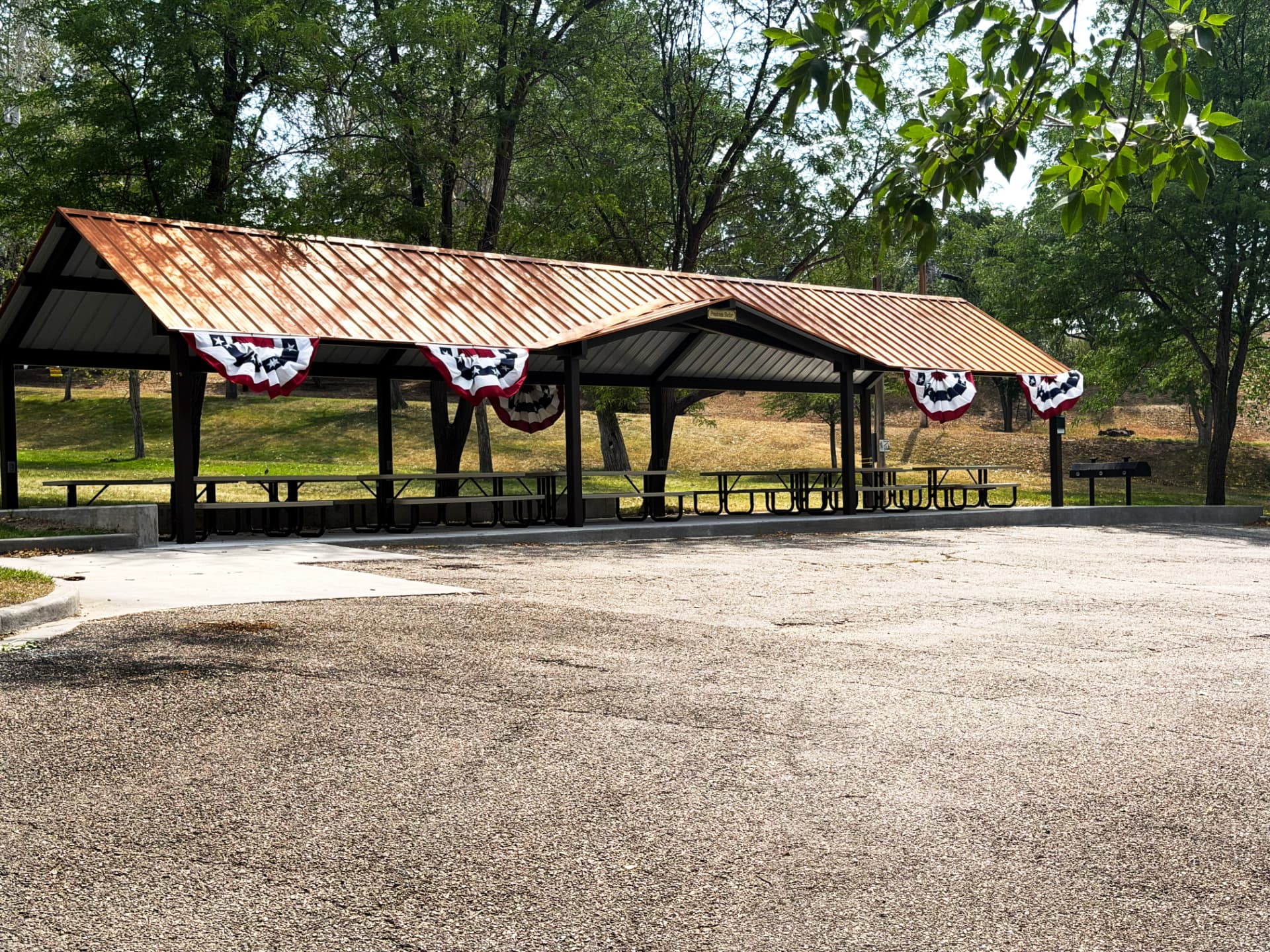 Community park shelter with picnic tables and playground