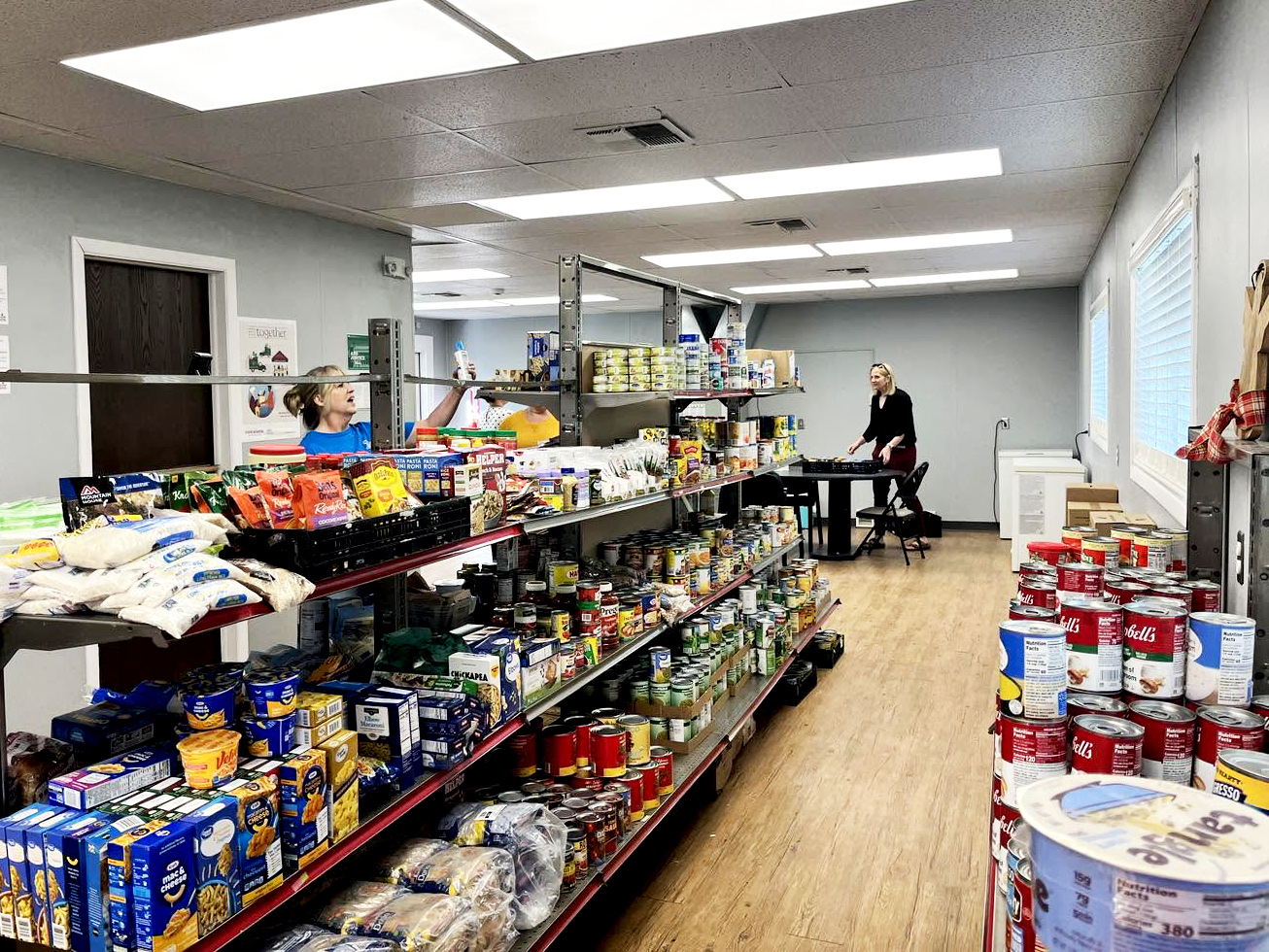 Local nonprofit volunteers sorting donated goods in a community hall
